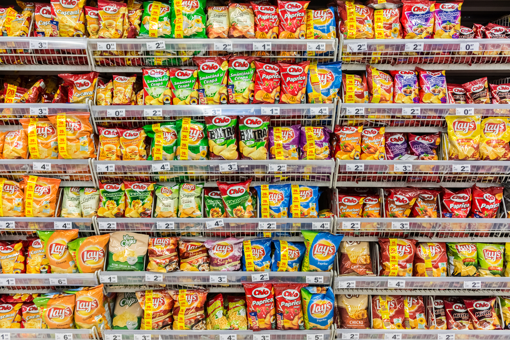 A wall of snack foods on store shelves.