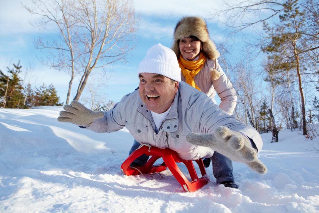 A man and a woman on a toboggan.