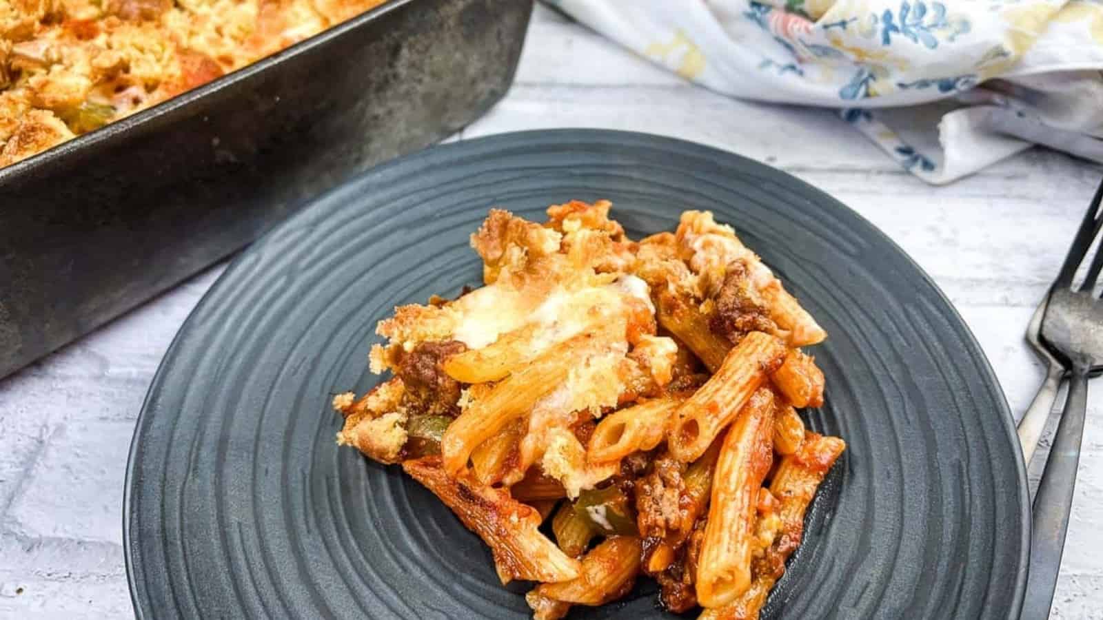 A closeup of Sloppy Joe Casserole on a plate with more in the background.