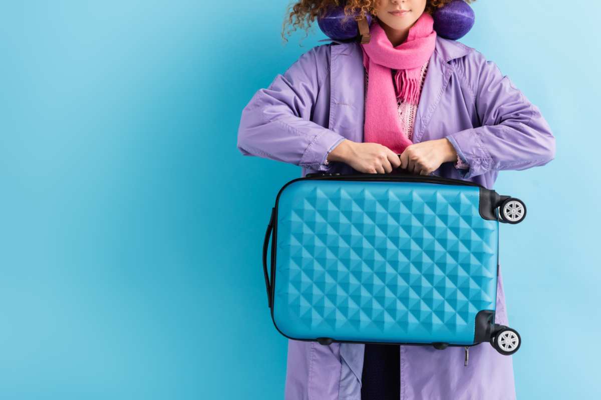 Woman carrying her carry on baggage.