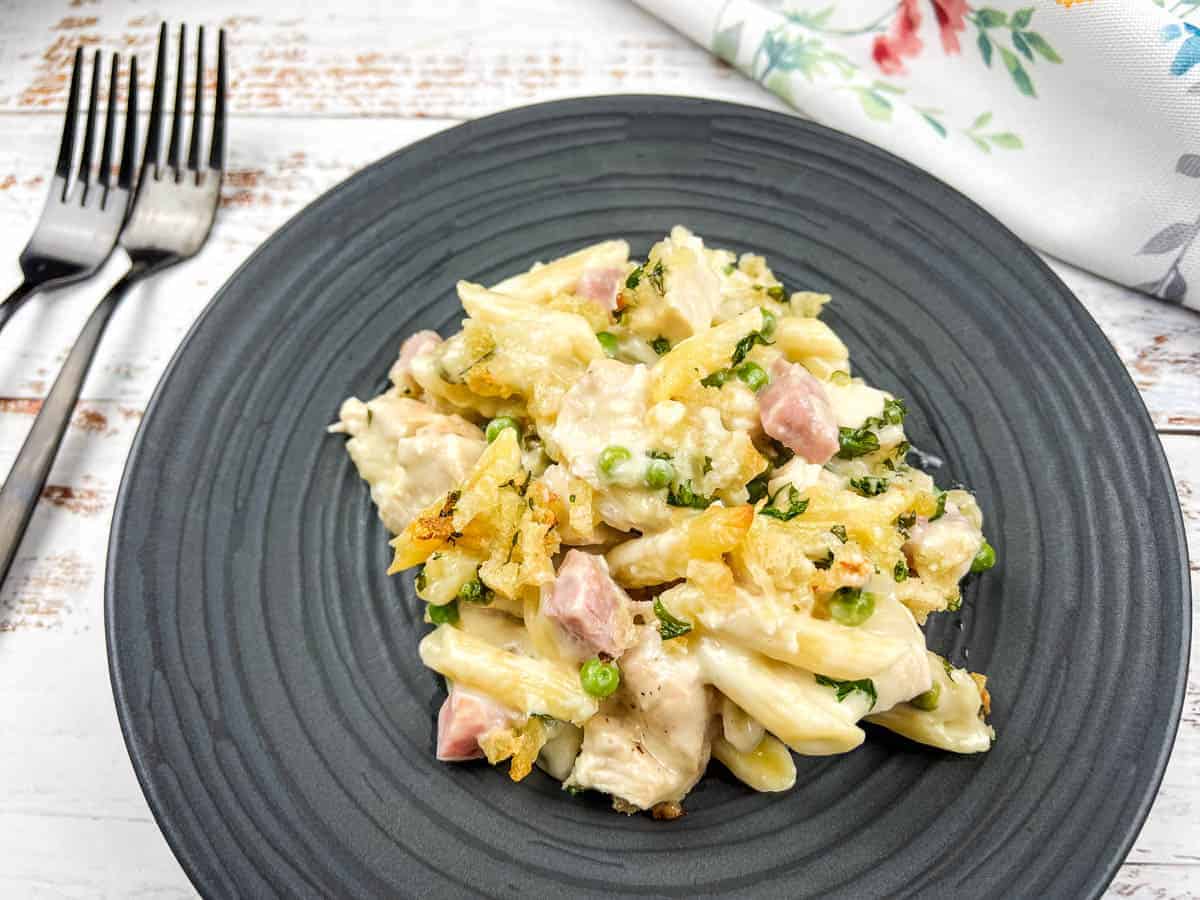 Chicken cordon bleu casserole on a black plate with a fork.