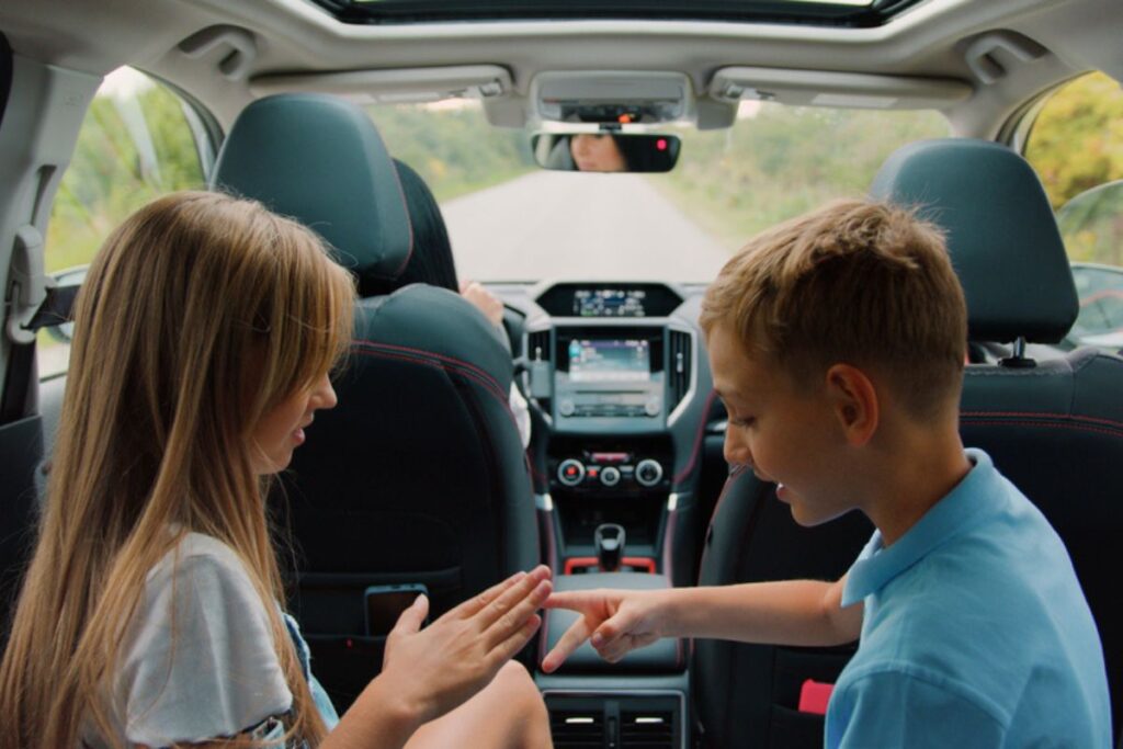 Kids playing inside the car.