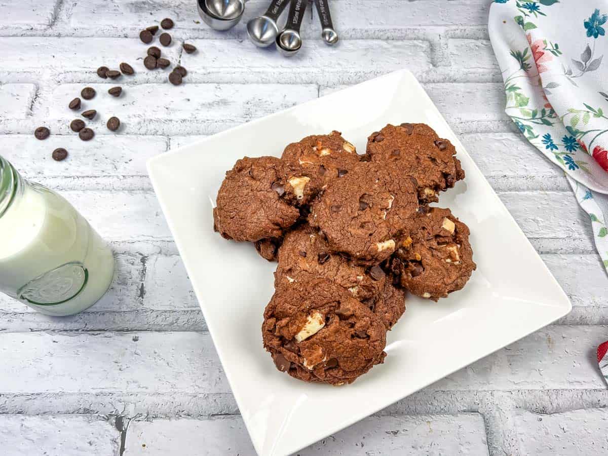 Chocolate overload cookies on a white plate.