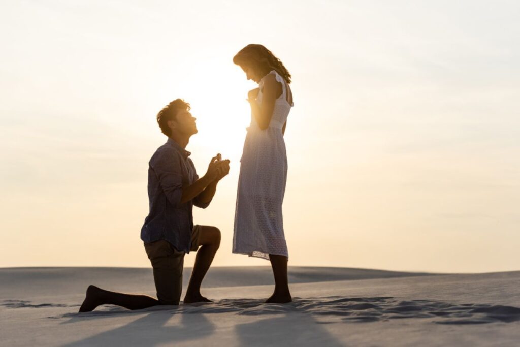 Photo of a man proposing to a woman.