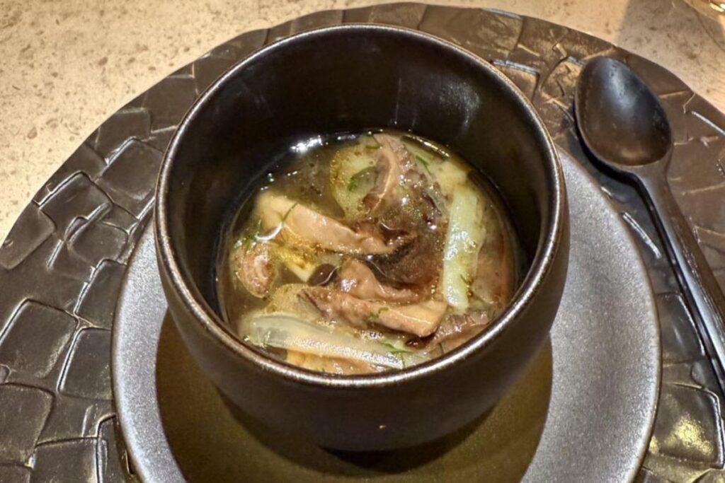 Morel Mustard Custard & Beef Tendon in a black bowl.