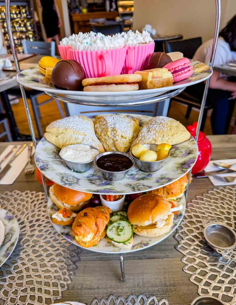A layered presentation of sweets and pies in Maddie Hatter Tea Shop.