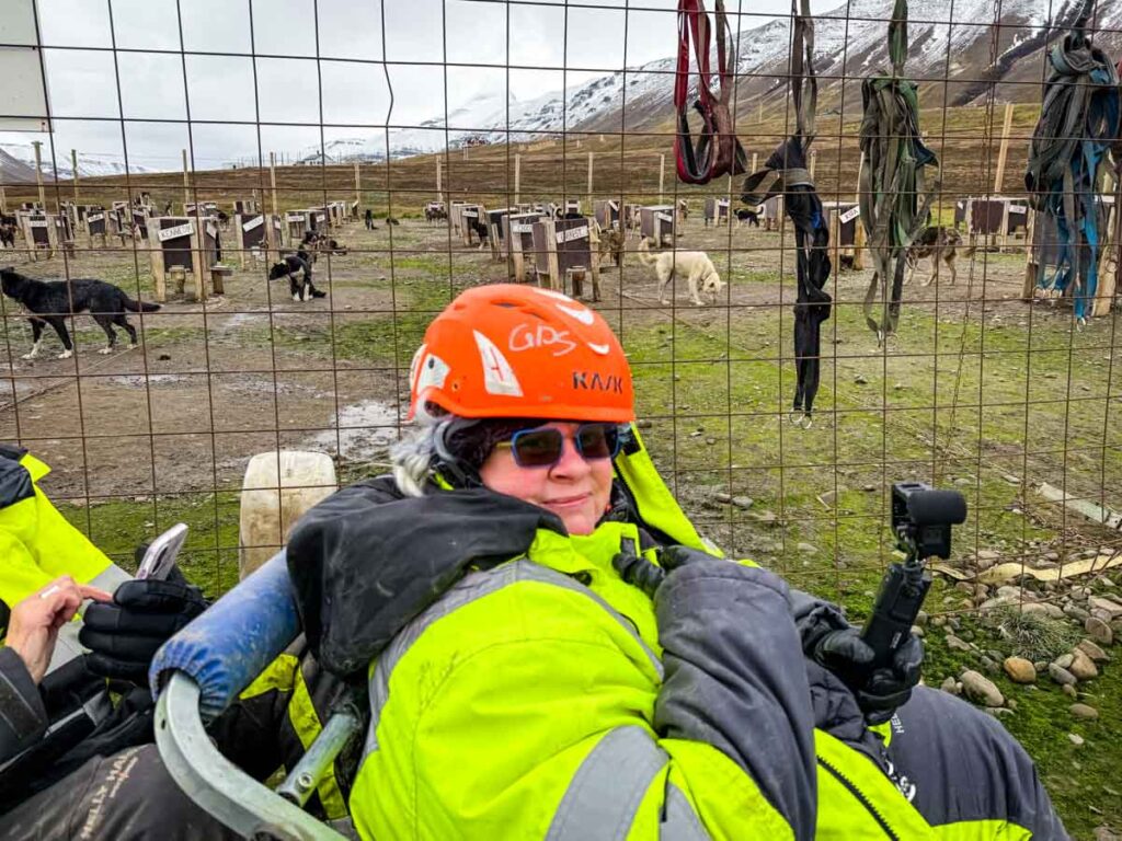Photo of Jenn with dogs in the background.