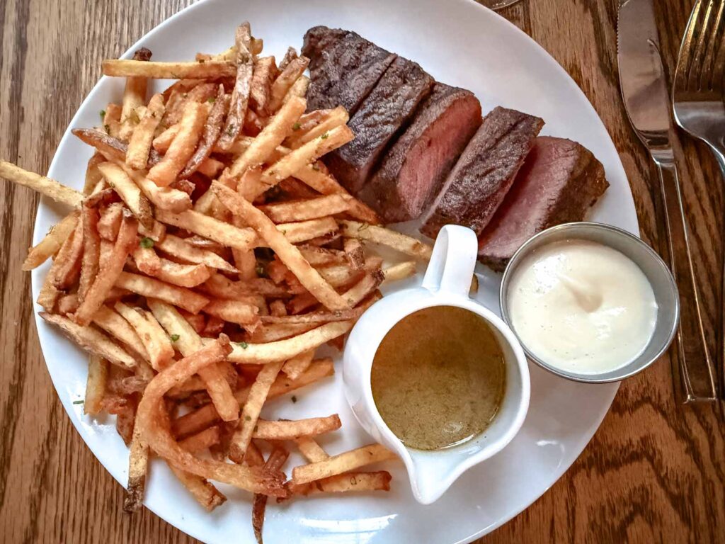 Steak frites on a plate.