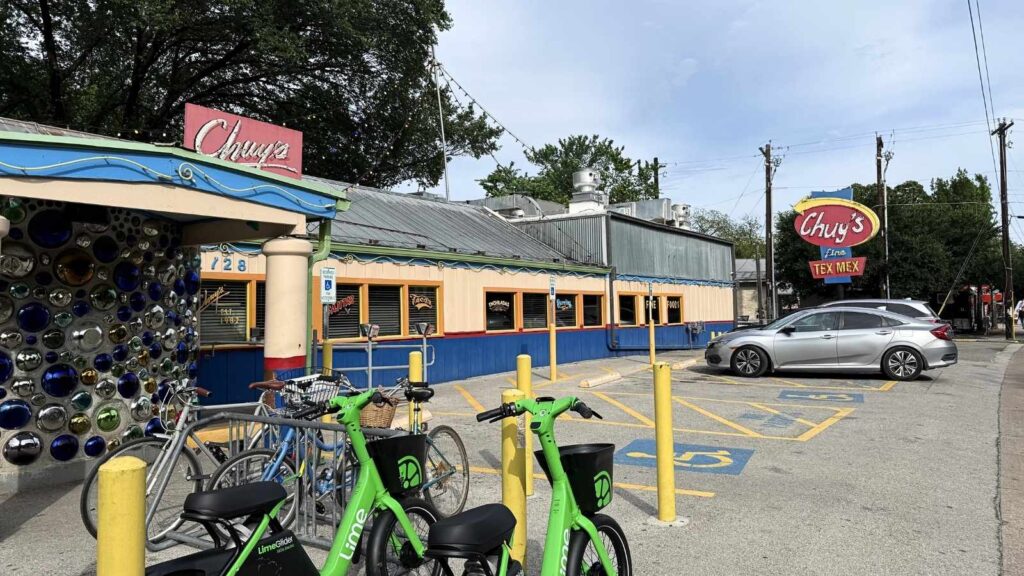 A horizontal image of the exterior of Chuy's Tex-Mex restaurant with a parking lot in front.